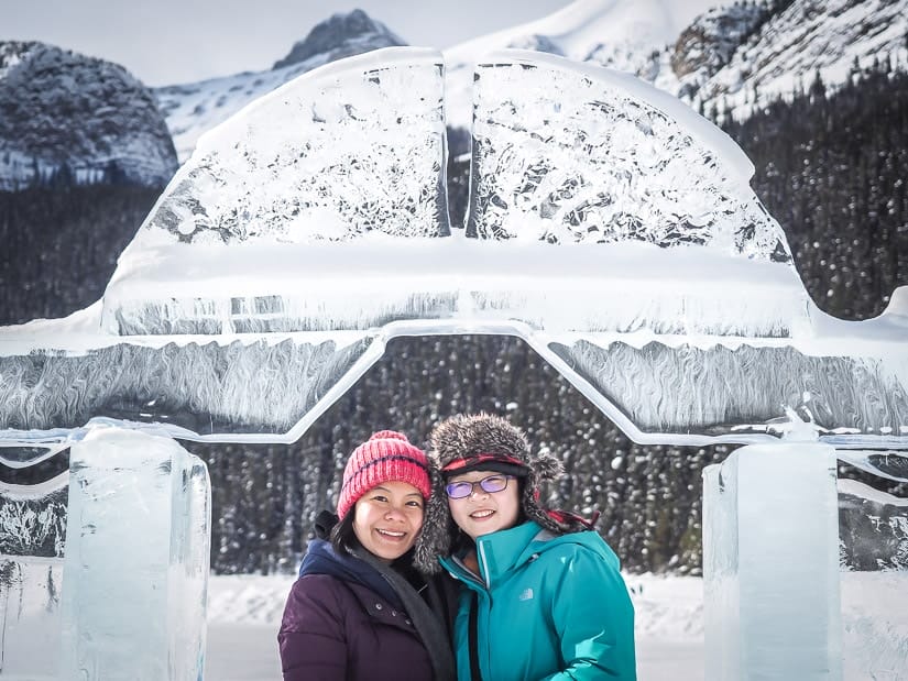 Two women standing in front of an ice castle at Lake Louise