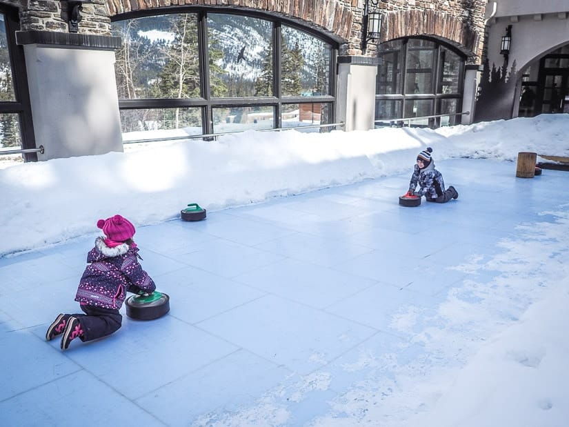 Our kids curling at Cave & Basin, a unique winter activity in Banff