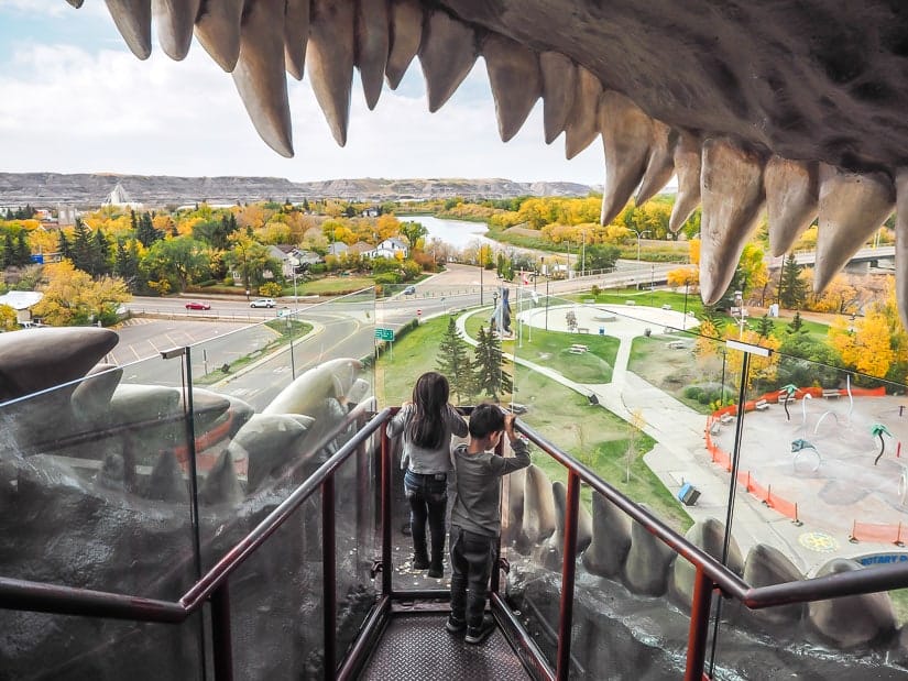 Two kids standing inside the mouth of the World's Largest Dinosaur in Drumheller Alberta