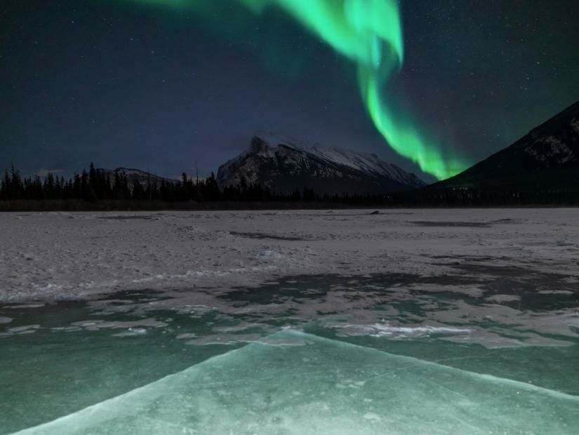 Northern lights above a frozen lake in Banff