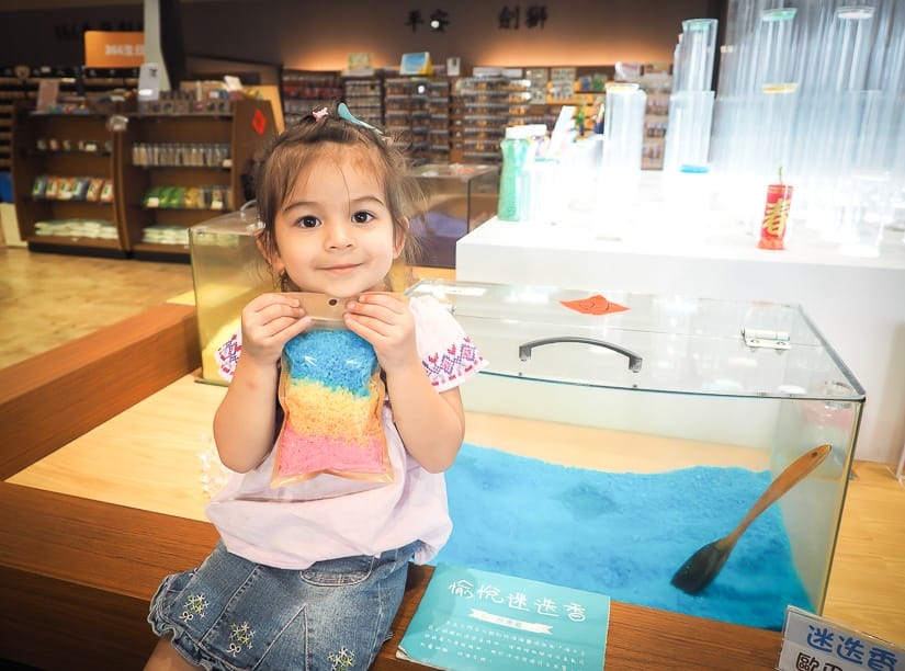 Girl holding bath salts in Tainan Qigu Salt Museum gift shop
