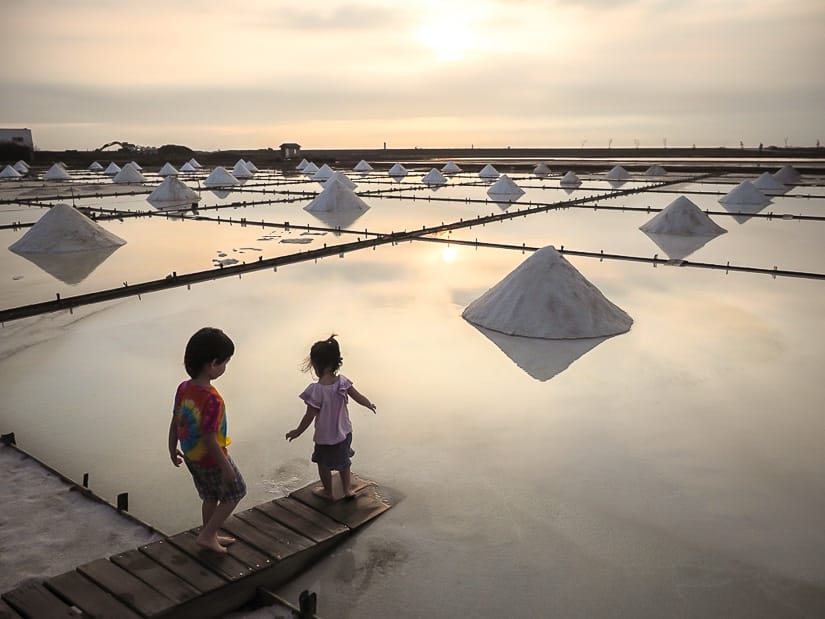 Two kids standing beside the salt fields in Tainan Taiwan
