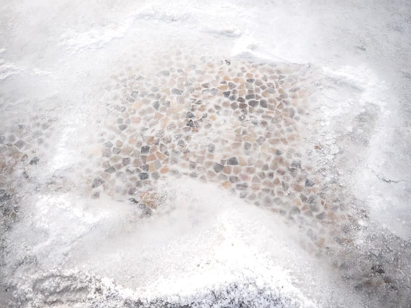 A salt brine pool with pieces of pottery on the bottom at Jingzijiao Wapan Salt Fields