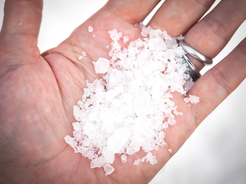 A hand holding some Taiwan-made salt from a local salt field in Tainan