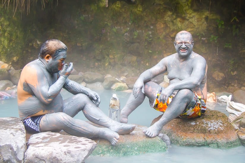 Two elderly men rubbing mud on their body at Bayan Hot Spring in Jinshan, New Taipei City