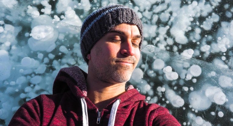 Me lying on some ice bubbles at Abraham Lake, Alberta, Canada