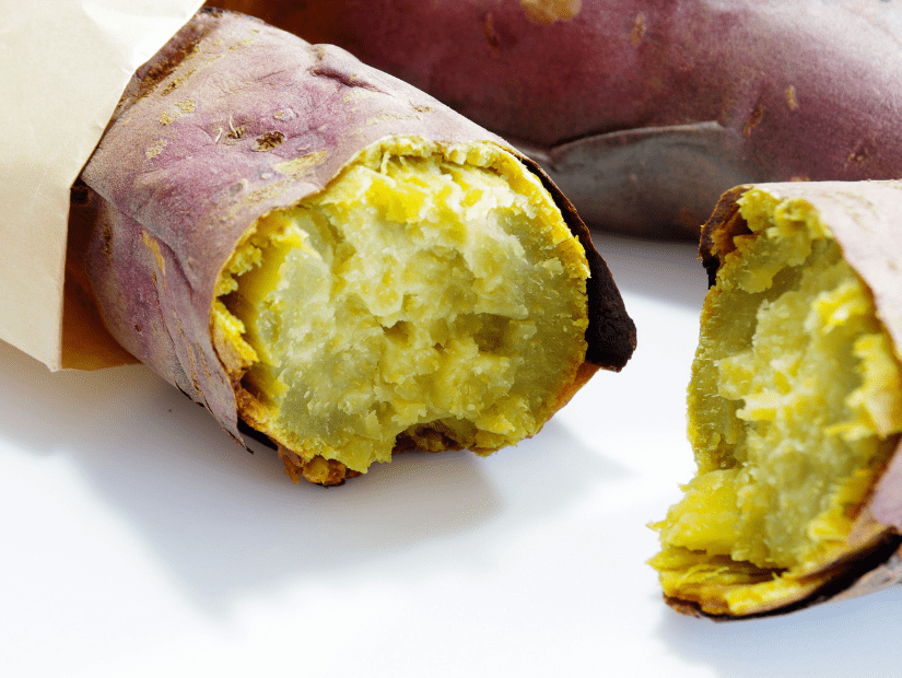 A baked yam/sweet potato in a paper bag