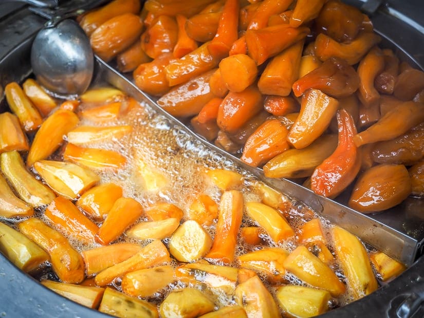 Candied sweet potatoes being prepared at a street food stall