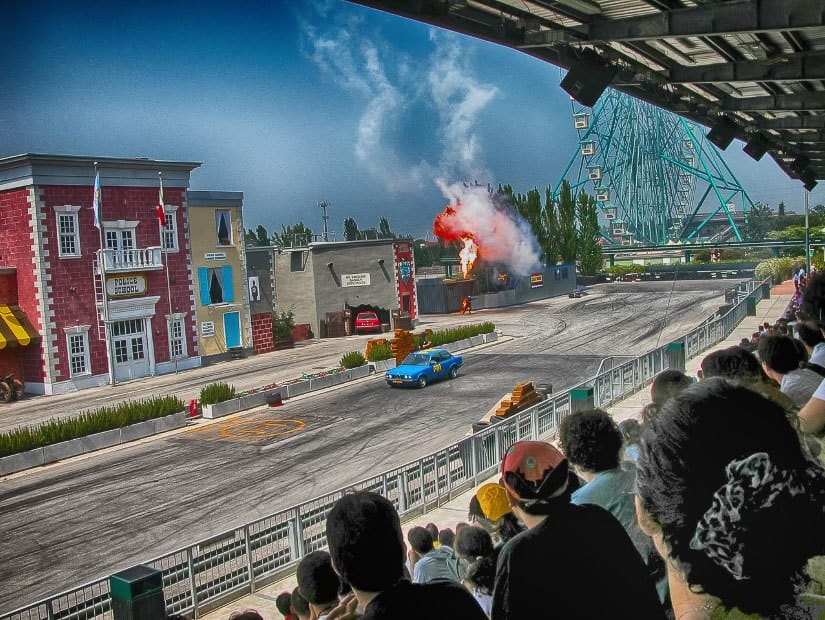 Crowd of people watching a family show at Gardaland, one of the best things to do with kids in italy