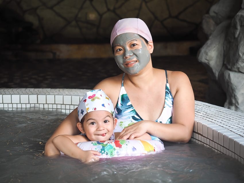 Woman and girl in mud hot spring at Kings Garden Villa in Guanziling