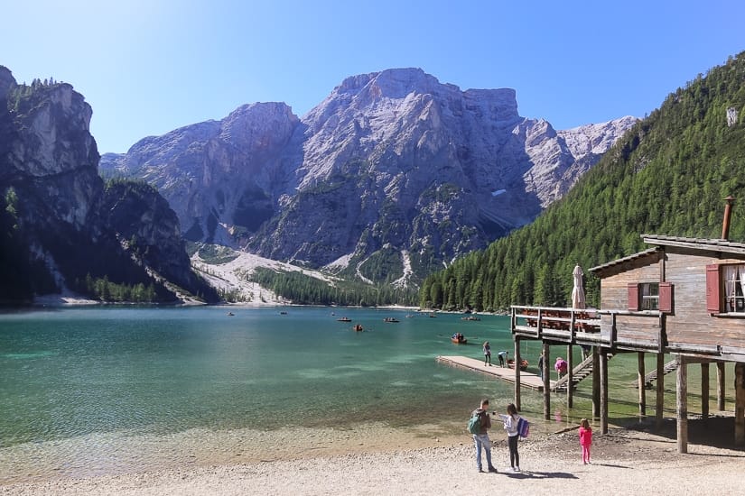 Some kids at a beautiful lake in the Dolomites of Italy