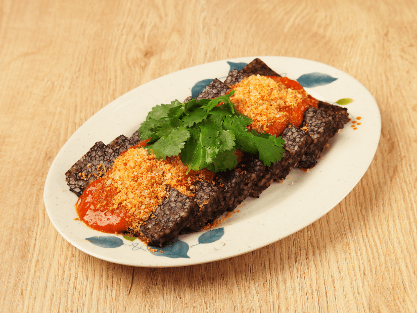 Taiwanese pig's blood cake with spicy sauce, cilantro, and ground peanuts