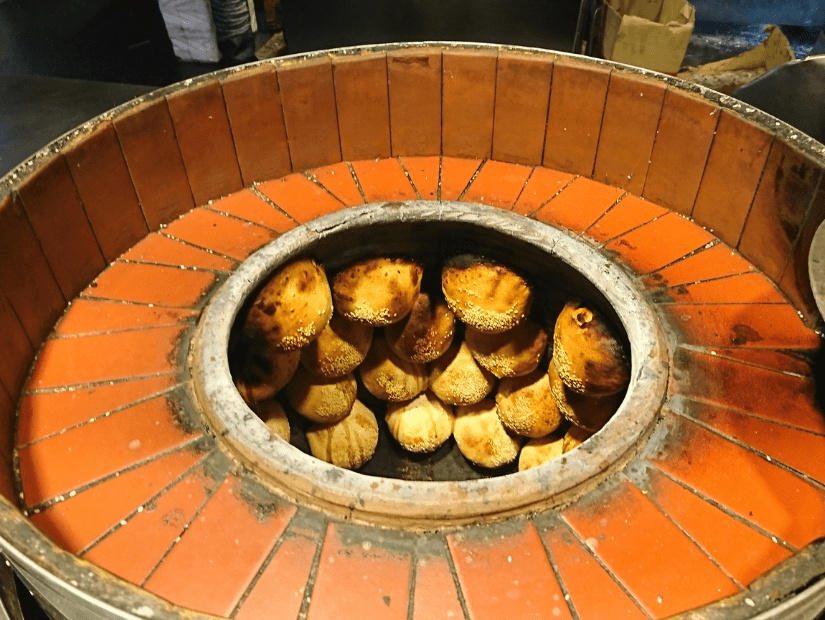 Black pepper buns on the inside of a clap oven