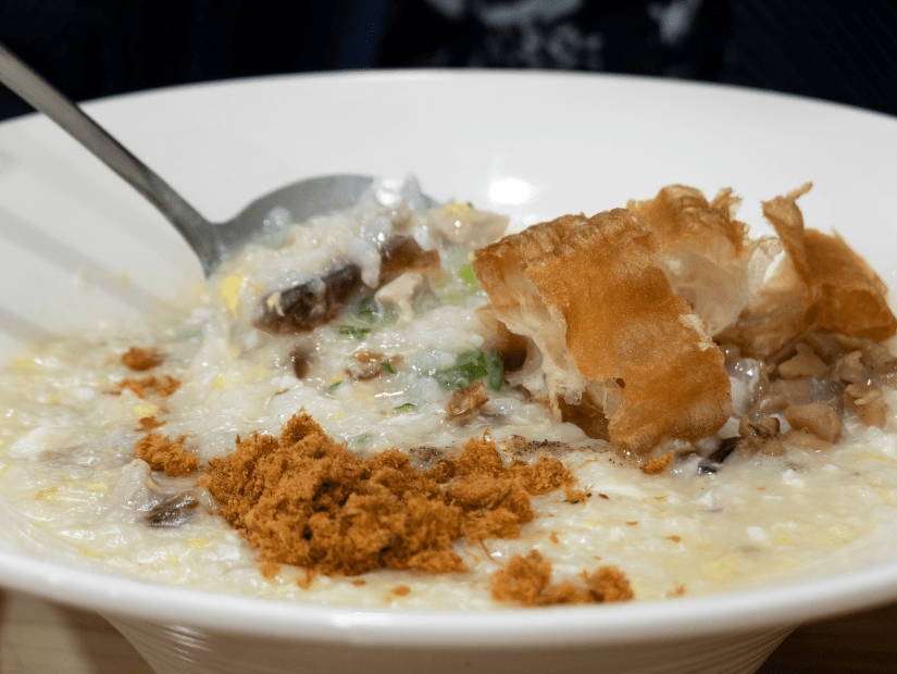 A bowl of Taiwanese congee with youtiao and other toppings
