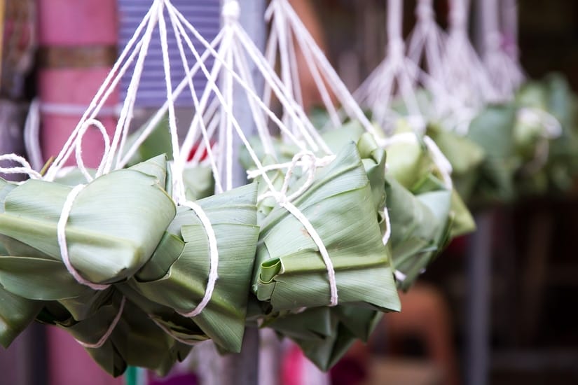 A bunch of sticky rice dumplings, or zongzi, hanging on the street in Taiwan