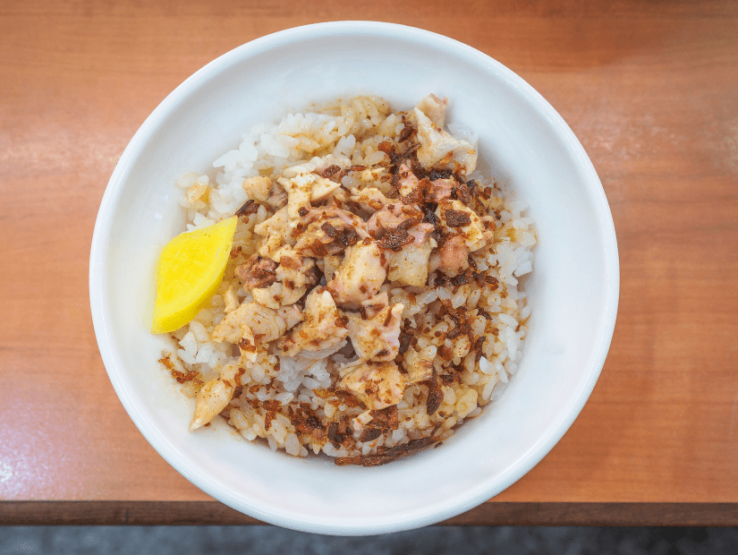 A bowl of Turkey rice, a specialty from Chiayi in Taiwan, on the edge of a table