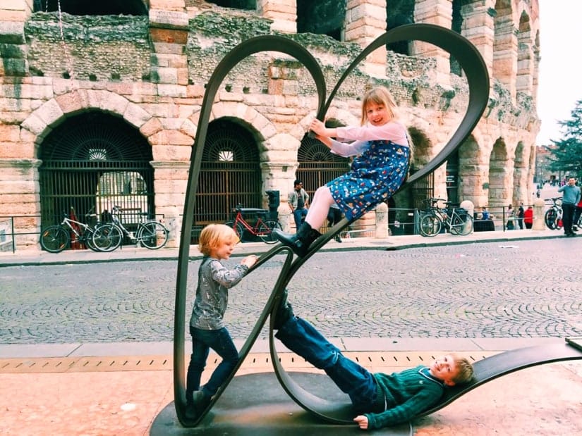 Some kid travelers playing on the streets in Verona Italy