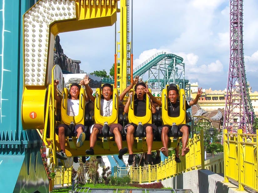 Four guys riding a rollercoaster and E-Da Theme Park in Kaohsiung