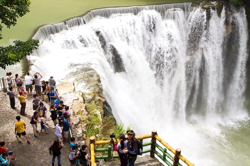 Crowd of people looking down at Shifen Waterfall