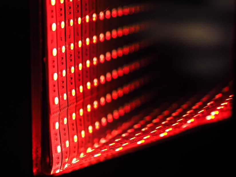 Rows of red LED lights framing the TV in the space themed room