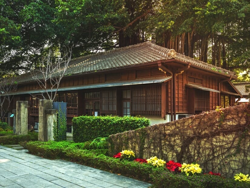 A wooden Japanese house and some flowers at Taichung Literature Museum