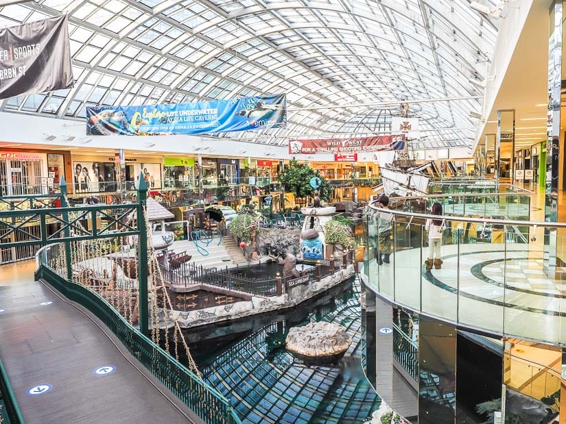 View of the interior of West Edmonton Mall and a bridge crossing its artificial lake