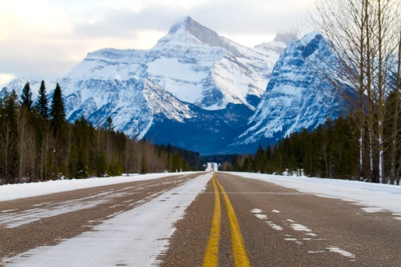 View of Highway 93 in winter in Jasper National Park, with mountains in background