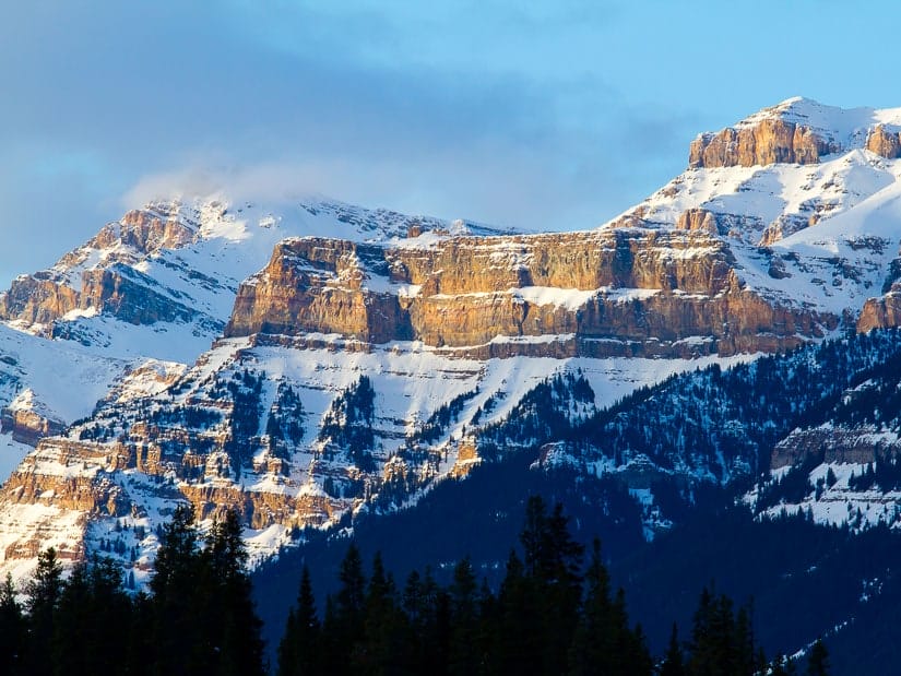 View of mountain peaks covered in snow and rocky cliffs on the Icefields Parkway in winter