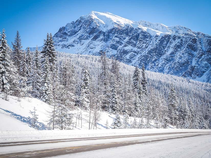 The icefields parkway in winter with mountains behind it