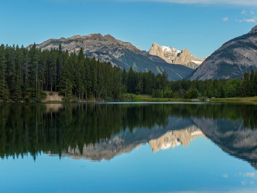 Mountains reflecting on Johnson Lake in Banff National Park