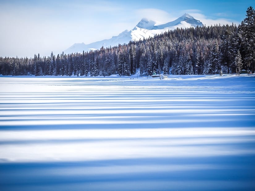 Shadows across a snow covered Maligne Lake in winter