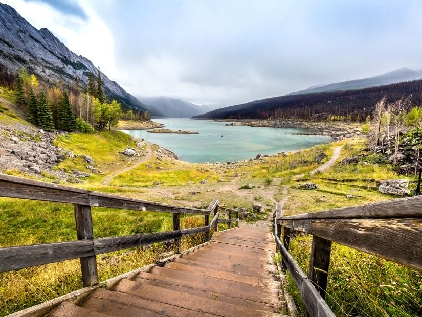 A wooden staircase leading down to Medicine Lake in Jasper National Park