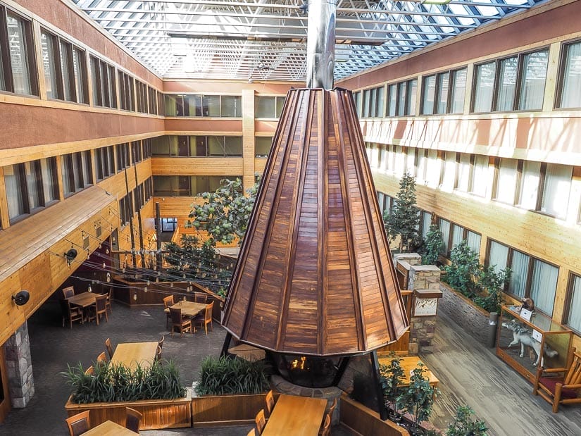 A tall teepee-shaped fireplace in a hotel courtyard at Sawridge hotel in Jasper