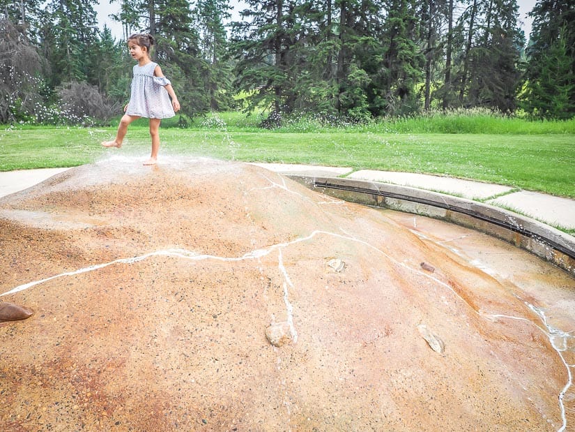 A kid playing in the fountain at Kin Kanyon Park Red Deer