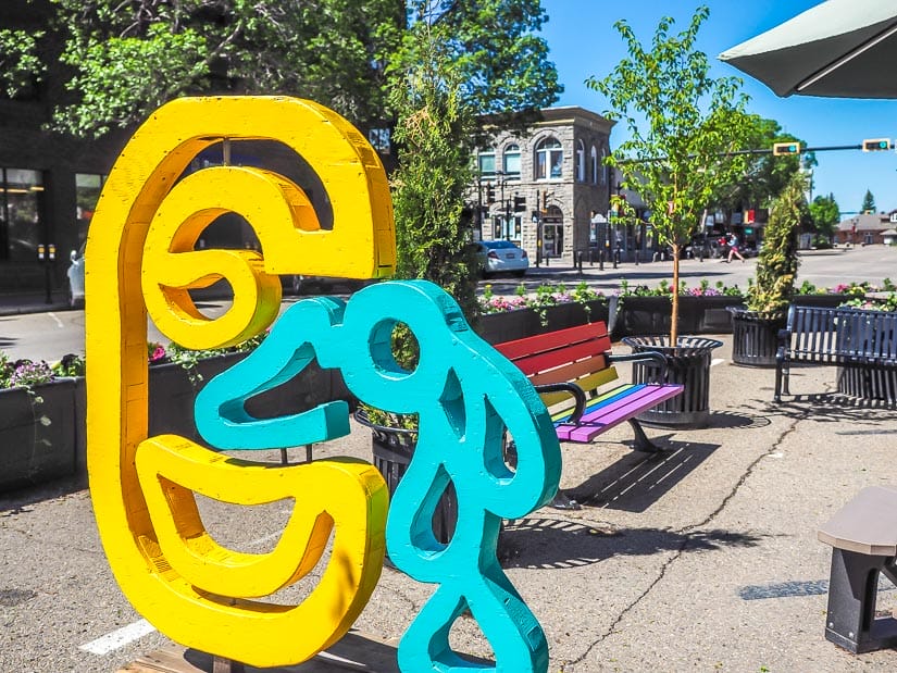 Artworks and a rainbow colored bench on Ross Street, one of the best places to go in Red Deer downtown