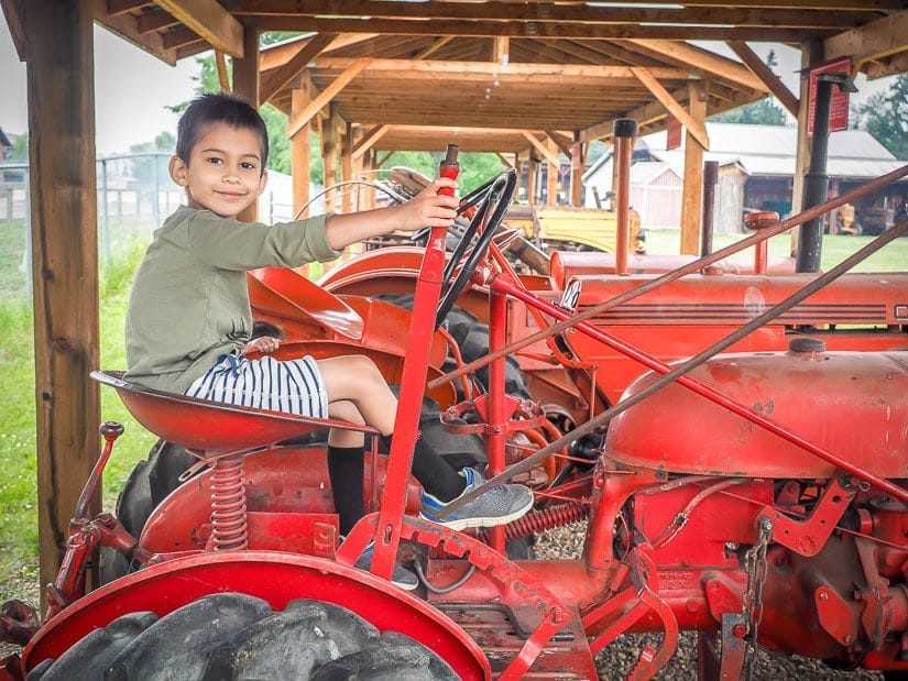 Boy riding a tractor at Sunnybrook Farm Museum