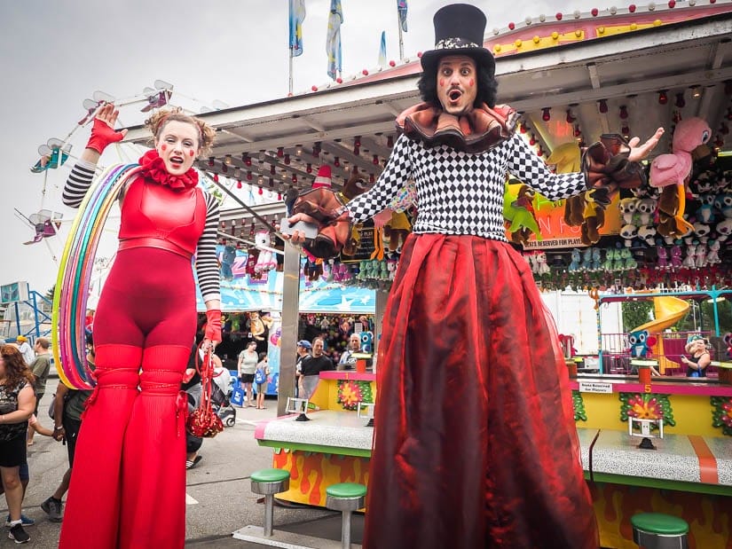 Man and woman standing on stilts at the Abbotsford Agrifair