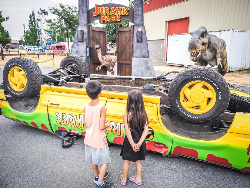 Two kids standing in front of a Jurassic Park exhibit at Agrifair