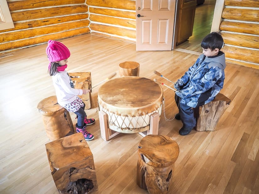 Two kids playing indigenous drums in Buffalo Nations Luxton Museum