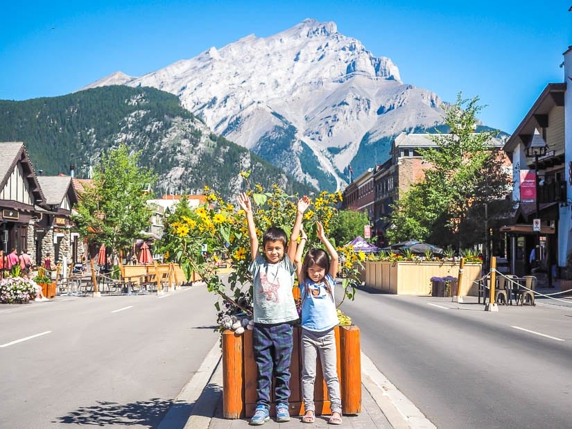 Two kids standing on Banff Avenue in summer