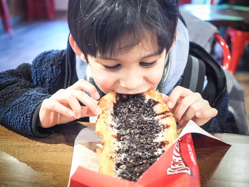 A kid eating a Beaver Tail in Jasper