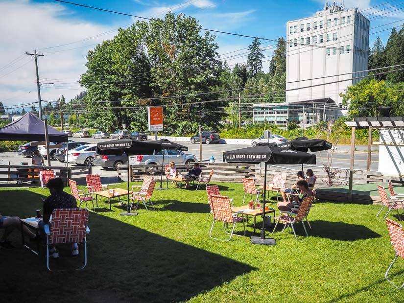 People drinking beer on a grassy patio at Field House Brewing, one of the best breweries in Abbotsford