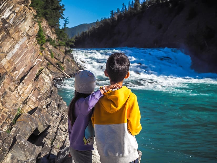 Two kids looking at Bow Falls