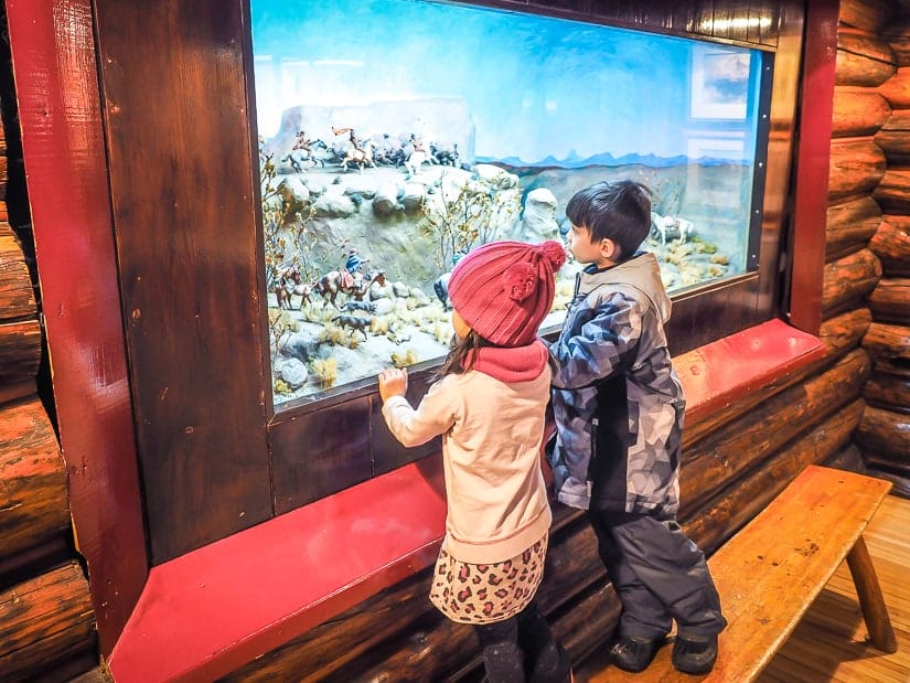 Two kids looking at a display in Buffalo Nations Luxton Museum in Banff