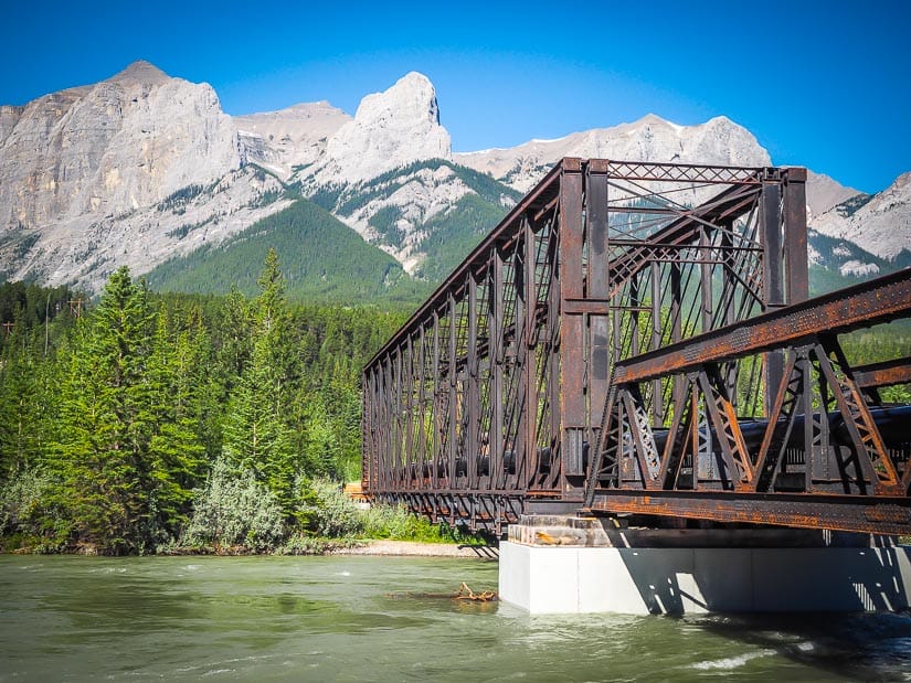 Canmore Engine Bridge over the Bow River, with mountains in the background, one of the best things to see in Canmore