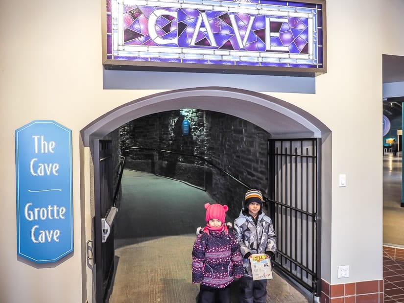 Two kids standing at the entrance to Cave & Basin National Historic Site in Banff