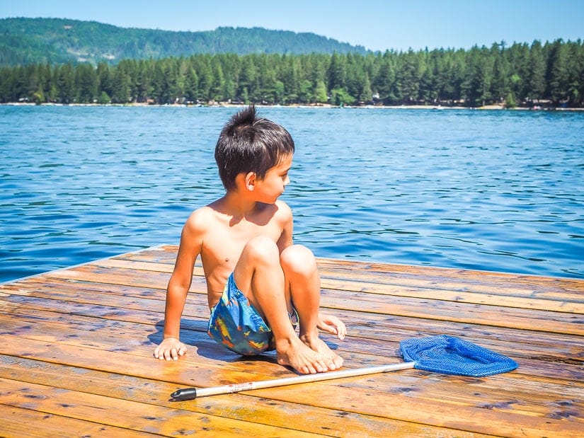 Kid sitting on the dock at Cultus Lake