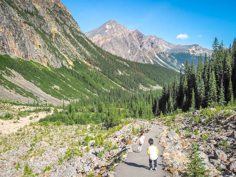 Two kids running down a hiking trail in Jasper National Park