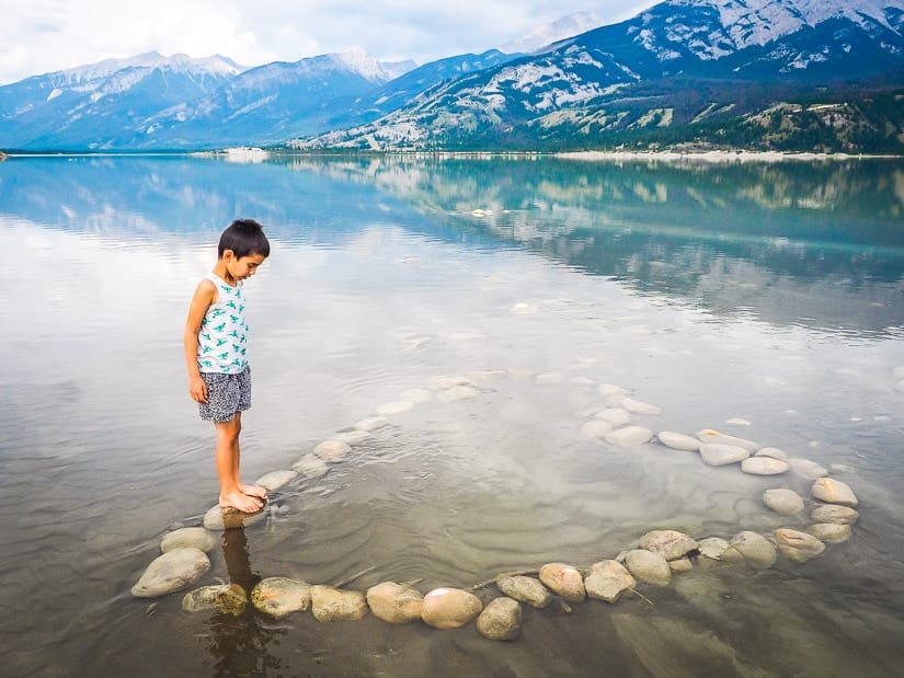 A kid standing on a heart made of stones in Jasper Lake