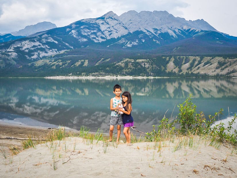 Two kids hugging beside Jasper Lake